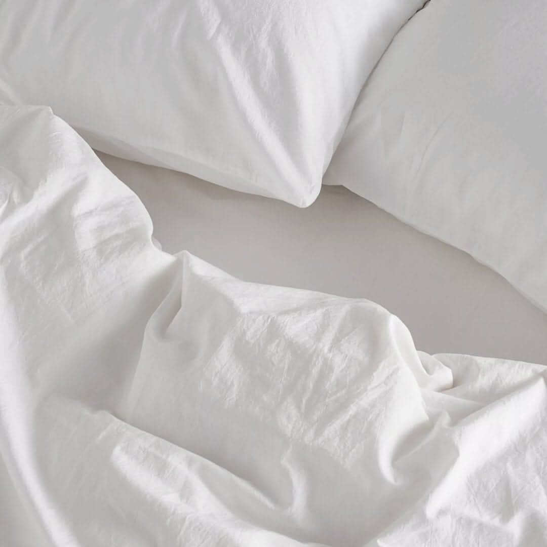 Stacked organic cotton sheets — breathable, soft, and ideal for a naturally healthy home.