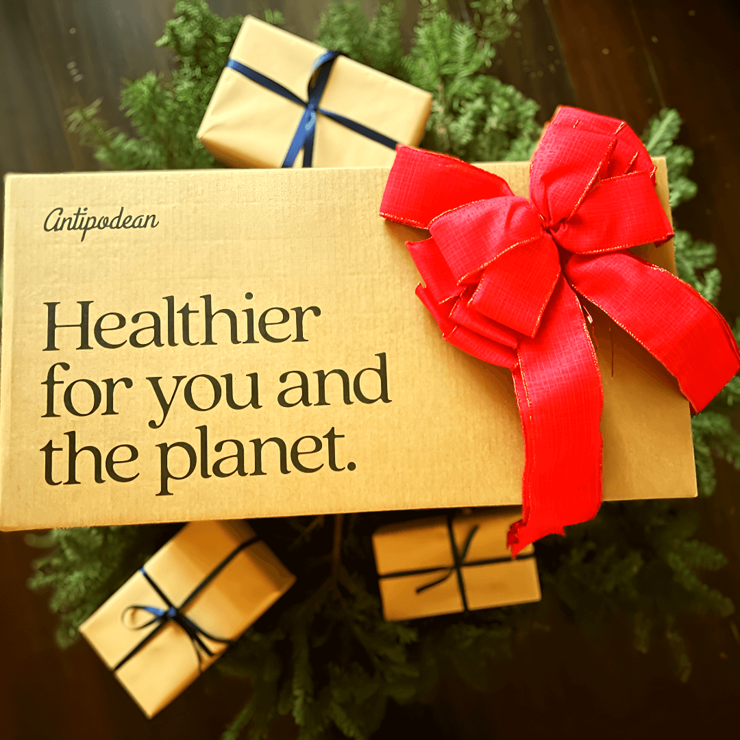 Antipodean Home eco-friendly holiday gift box with red ribbon — sustainable packaging that’s healthier for you and the planet, made from regenerative New Zealand materials.