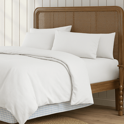 Sustainable wool comforter on bed with organic cotton cover in serene, minimalist bedroom